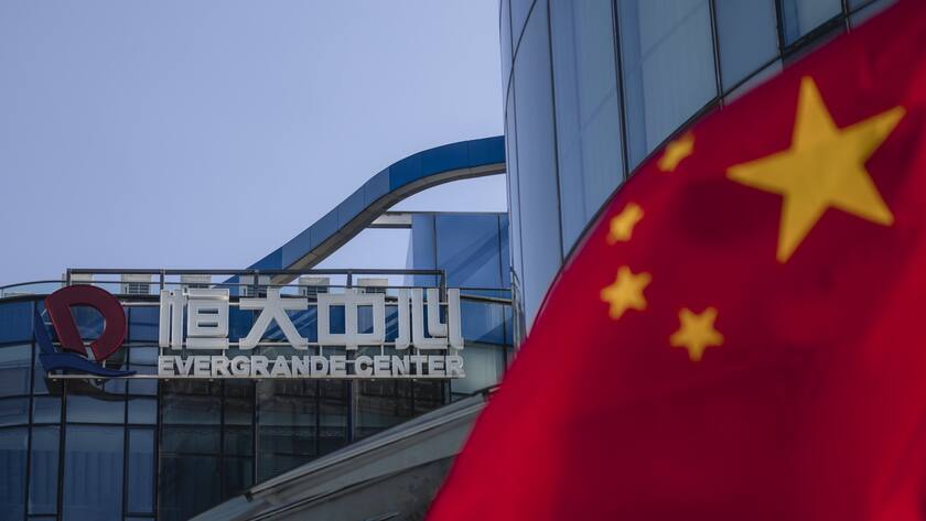 A logo and Chinese flag are seen in front of the Evergrande Center in Shanghai, China, 23 September 2021.