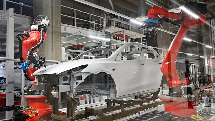 09.10.2021, Brandenburg, Grünheide: Roboter bei der Fertigung vom Tesla Model Y zum Tag der offenen Tür in einer Produktionshalle der Tesla Gigafactory. In Grünheide, östlich von Berlin, sollen ab Ende 2021 die ersten Fahrzeuge vom Band rollen. Tausende Besucher werden zum Tag der offenen Tür auf der Baustelle der ersten europäischen Fabrik des US-Elektroautobauers Tesla bei Berlin erwartet. Foto: Patrick Pleul/dpa-Zentralbild/ZB +++ dpa-Bildfunk +++ (KEYSTONE/DPA/Patrick Pleul)