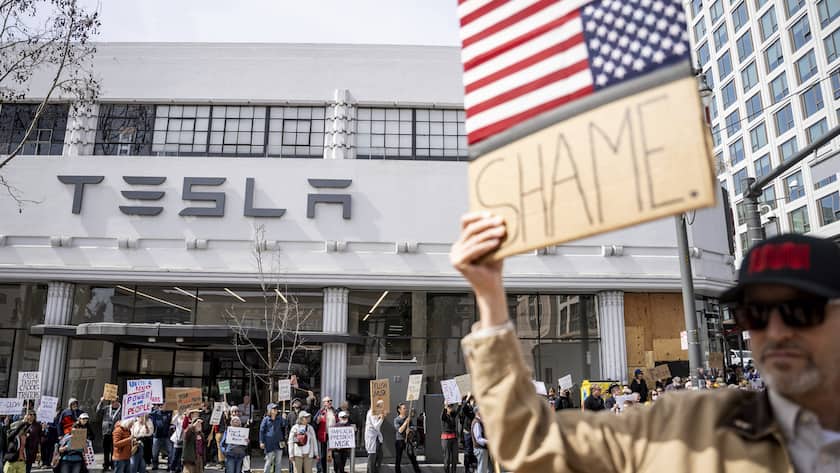Protesters rally outside a Tesla dealership in San Francisco, Saturday, March 15, 2025. (AP Photo/Josh Edelson)