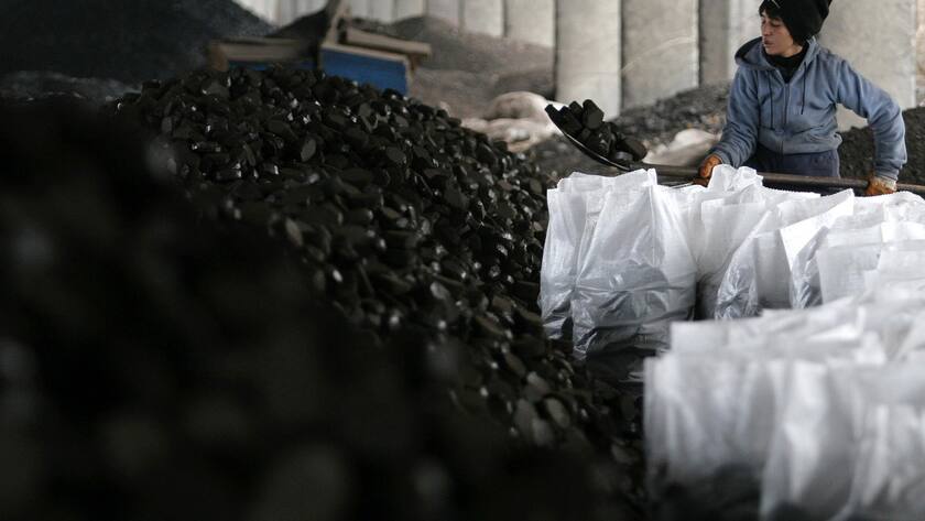 A woman collects coal at an open air coal market in the town of Varna east of the Bulgarian capital Sofia, Wednesday, Jan. 7, 2009, as gas supplies are threatened and supplies of other fuels have become the focus of attention. Bulgaria's energy ministry has revealed that Russian gas supplies to Bulgaria are suspended for an indefinite period, along with supplies to other European countries, Turkey, Greece and Macedonia. (AP Photo/Petko Momchilov)