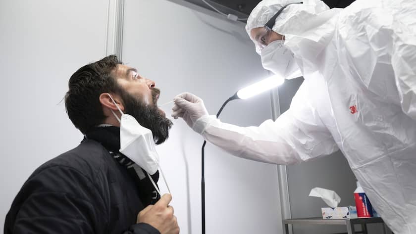 Danilo Schulz sits during a Corona quick test at the Johanniter Corona Test Center in the Palace of Culture in Dresden, Germany, Wednesday, March 16, 2022. (Sebastian Kahnert/dpa via AP)