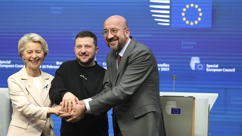 From left, European Commission President Ursula von der Leyen, Ukraine's President Volodymyr Zelenskyy, center, and European Council President Charles Michel join hands after addressing a media conference at an EU summit in Brussels on Thursday, Feb. 9, 2023. European Union leaders are meeting for an EU summit to discuss Ukraine and migration. (AP Photo/Olivier Matthys)