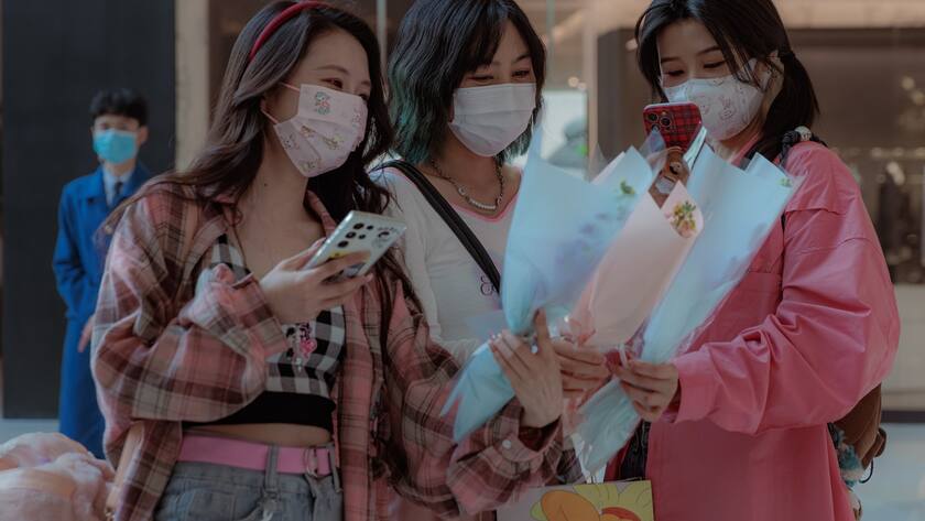 epa10508857 Women walk around a shopping mall with flowers given to them by mall hostesses on the occasion of International Women's Day, in Shanghai, China, 08 March 2023. Since 2014, women in China have been entitled to a half-day off work on this occasion. International Women's Day (IWD) is observed annually on 08 March to highlight women's rights, as well as issues such as violence and abuse against women. EPA/ALEX PLAVEVSKI