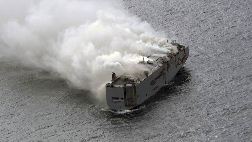 Smoke is seen from a freight ship in the North Sea, about 27 kilometers (17 miles) north of the Dutch island of Ameland, Wednesday, July 26, 2023. A fire on the freight ship Fremantle Highway, carrying nearly 3,000 cars, was burning out of control Wednesday in the North Sea, and the Dutch coast guard said it was working to save the vessel from sinking close to an important habitat for migratory birds. (Kustwacht Nederland/Coast Guard Netherlands via AP)