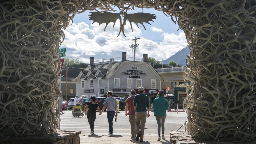 Tourists walk around Town Square in Jackson, Wyo. on Aug. 23, 2023. When Federal Reserve Chair Jerome Powell delivers a high-profile speech Friday in Jackson Hole, many analysts think he could make one thing clear: That the Fed plans to keep its benchmark interest rate at a peak level for longer than had been expected. (AP Photo/Amber Baesler)