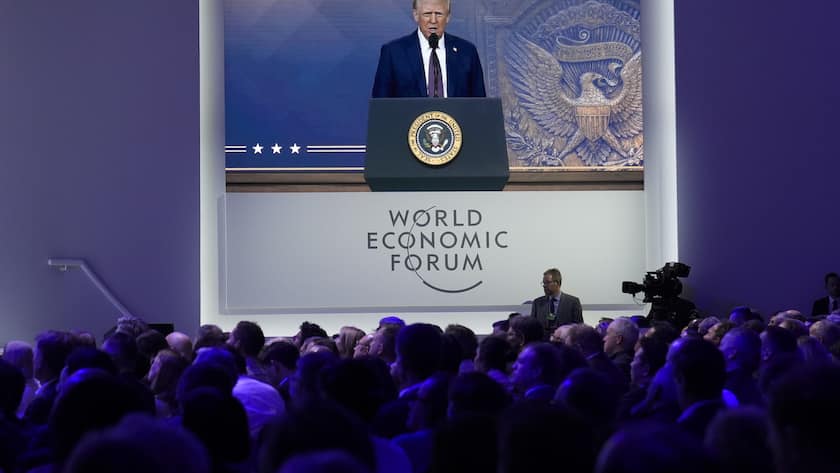Attendees listen to a virtual speech delivered by U.S. president Donald Trump, at the Annual Meeting of World Economic Forum in Davos, Switzerland, Thursday, Jan. 23, 2025. (AP Photo/Markus Schreiber)