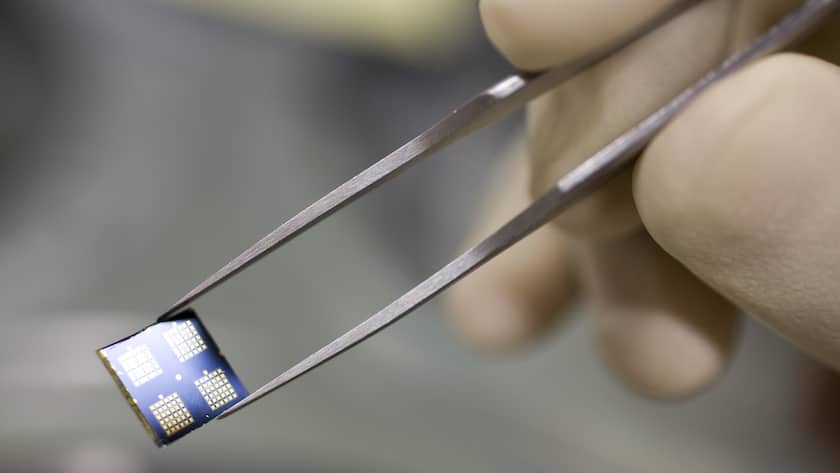 An employee of IBM's research laboratory in Rueschlikon in the canton of Zurich, Switzerland, holds an IBM microchip into the camera
