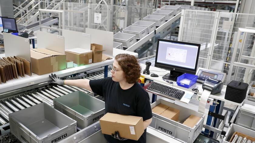 Employees man an automated distribution array intake system that sorts and picks materials from a storage array at the FESTO distribution facility, Thursday, Feb. 23, 2017 in Mason, Ohio. (AP Photo/John Minchillo)