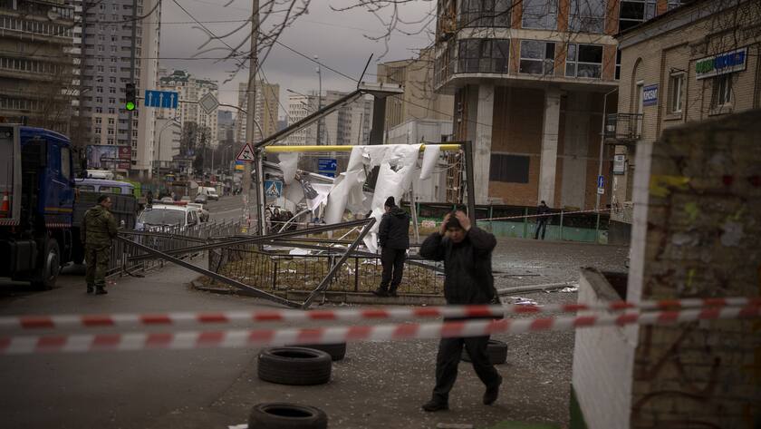 Police officers inspect area after an apparent Russian strike in Kyiv Ukraine, Thursday, Feb. 24, 2022. Russian President Vladimir Putin on Thursday announced a military operation in Ukraine and warned other countries that any attempt to interfere with the Russian action would lead to "consequences you have never seen." (AP Photo/Emilio Morenatti)
