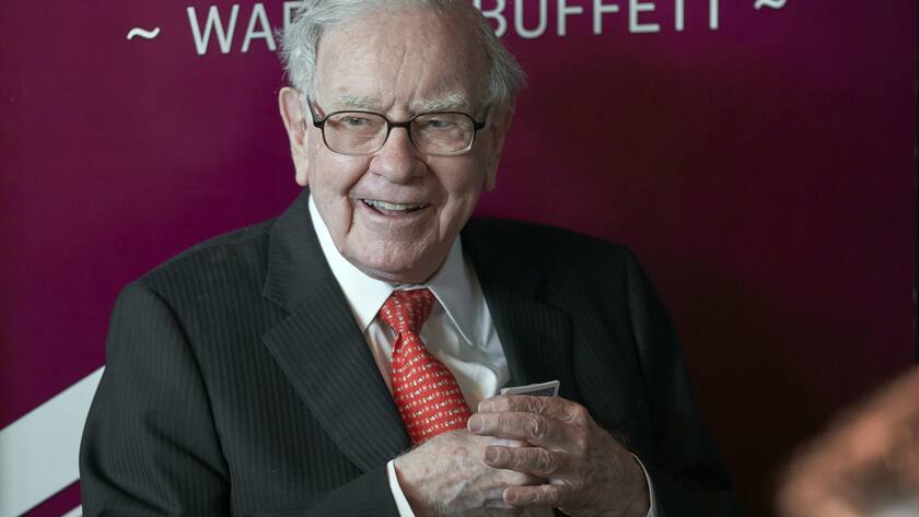 FILE - In this May 5, 2019, file photo Warren Buffett, Chairman and CEO of Berkshire Hathaway, smiles as he plays bridge following the annual Berkshire Hathaway shareholders meeting in Omaha, Neb. Berkshire Hathaway’s steady-as-she-goes investing has put the vast conglomerate in high places, or at least put the company's shares up there. Buying a single share of Berkshire’s class A stock will now set you back more than $500,000. (AP Photo/Nati Harnik, File).Warren Buffett
