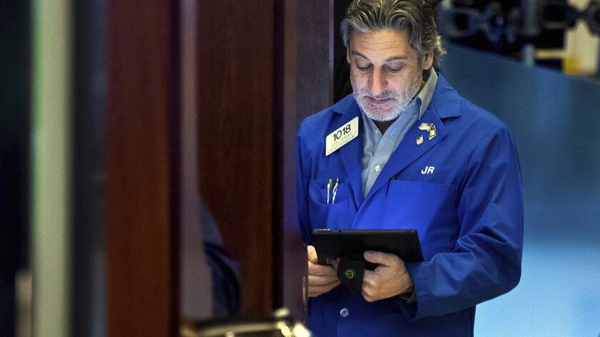 Trader John Romolo works on the floor, Monday, March 14, 2022, in this photo provided by the New York Stock Exchange. Stocks are losing ground on Wall Street in choppy trading Monday afternoon and bond yields are rising sharply as anxiety over the war in Ukraine and an upcoming Federal Reserve meeting on interest rates keep global financial markets on edge. (Allie Joseph/New York Stock Exchange via AP)