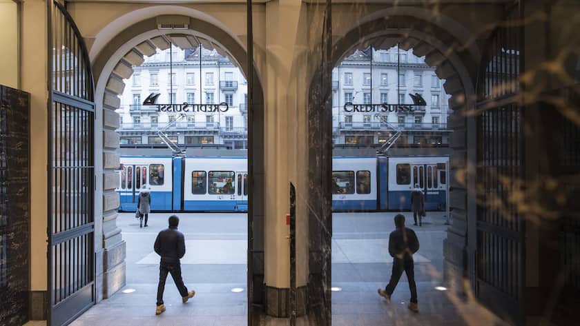 People walk in the front of the Credit Suisse bank at the tram stop Paradeplatz in the square's centre in Zurich, Switzerland, Wednesday, Feburary 14, 2018. (KEYSTONE/Ennio Leanza).