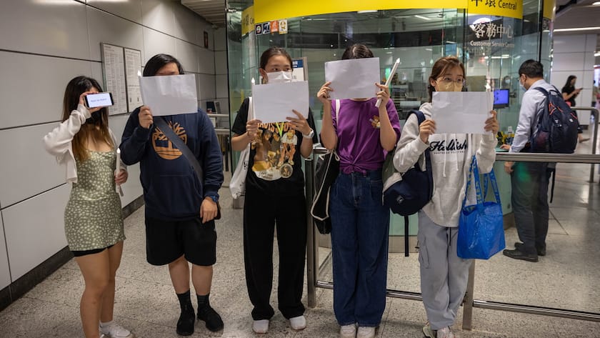 epa10334258 Mourners hold blank sheets of paper in an MTR station during a vigil for the victims of China’s zero-COVID policy and the victims of the Urumqi fire in Hong Kong, China, 28 November 2022. Protests against China's strict COVID-19 restrictions have erupted in various cities including Beijing and Shanghai, triggered by a tower fire that killed 10 people in Xinjiang’s capital, Urumqi. EPA/JEROME FAVRE
