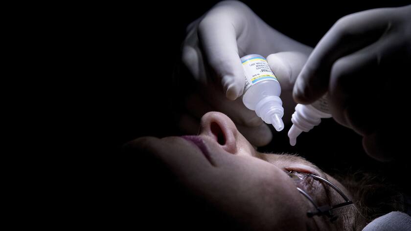 Dr. Mark Whitten uses anti-bacterial drops at the conclusion of a short eye surgery procedure on patient Christianne Krupinsky in Washington, Wednesday, Feb. 1, 2017, to insert a Raindrop inlay, a disc implanted in the cornea to reshape it for better close-up focus. This new kind of eye implant corrects presbyopia, the need for reading glasses that eventually hits all of us, usually starting in the 40s. (AP Photo/Andrew Harnik)