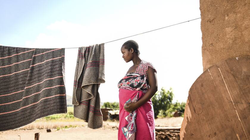 A pregnant woman waits to see Lucy Mbewe, a traditional birth attendant at her home in Simika Village, Chiradzulu, southern Malawi, Sunday, May 23, 2021. Health officials in Malawi say fewer women are getting prenatal care amid the COVID-19 pandemic. At risk are the developing country's gains on its poor rate of maternal deaths. (AP Photo/Thoko Chikondi)