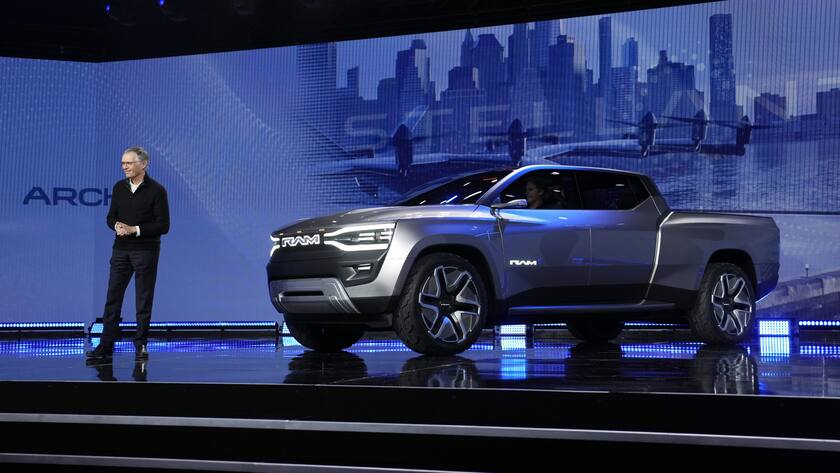 Stellantis CEO Carlos Tavares stands beside the Ram 1500 Revolution electric battery powered pickup truck during the CES tech show Thursday, Jan. 5, 2023, in Las Vegas. (AP Photo/John Locher)