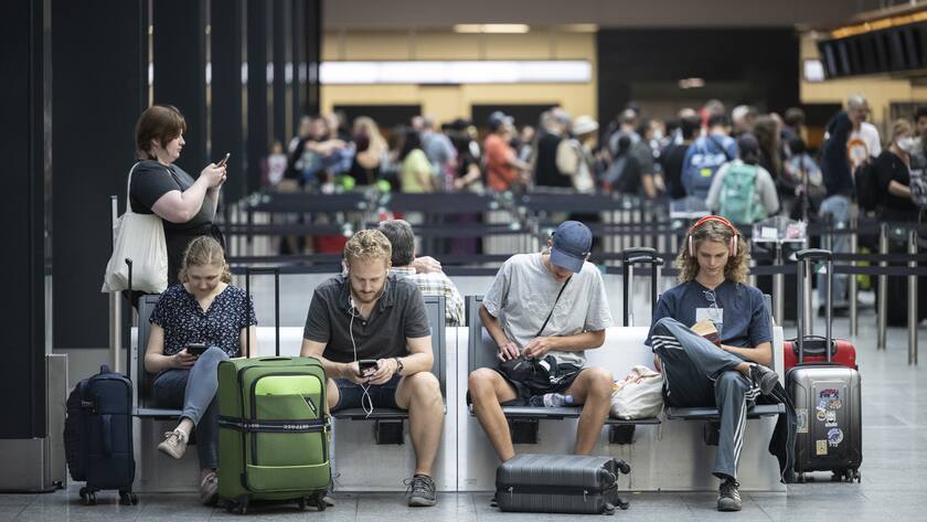Menschen warten am Flughafen auf ihren Abflug in die Ferien, aufgenommen am Samstag, 16. Juli 2022 auf dem Flughafen in Zuerich. (KEYSTONE/Ennio Leanza)