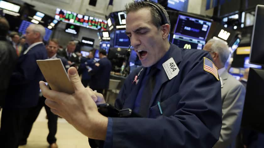 Trader Gregory Rowe works on the floor of the New York Stock Exchange, Wednesday, July 11, 2018. Stocks are opening lower on Wall Street, following declines in Europe and Asia, after Washington threatened to expand tariffs on Beijing and China said it would retaliate. (AP Photo/Richard Drew)