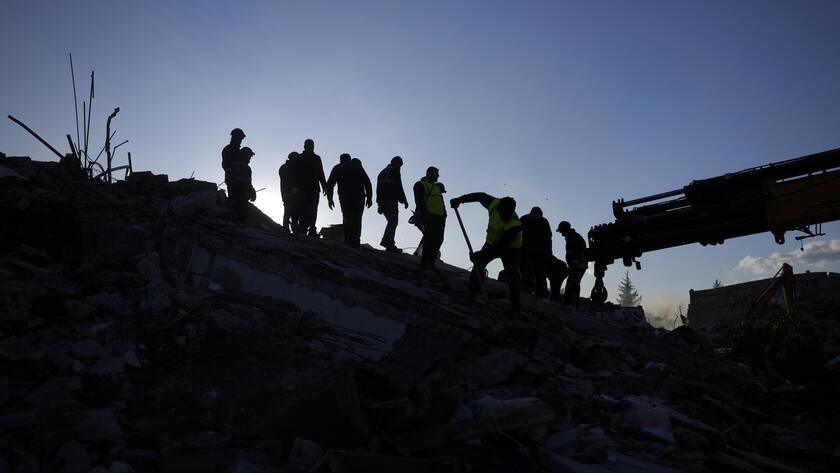 Rescue teams search for people in the rubble of destroyed buildings in Antakya, southern Turkey, Wednesday, Feb. 8, 2023. With the hope of finding survivors fading, stretched rescue teams in Turkey and Syria searched Wednesday for signs of life in the rubble of thousands of buildings toppled by a catastrophic earthquake. (AP Photo/Khalil Hamra)