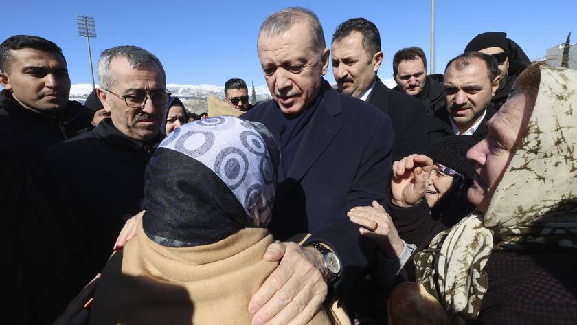 Turkey's President Recep Tayyip Erdogan and a survivor speak as he visits the city center destroyed by Monday earthquake in Kahramanmaras, southern Turkey, Wednesday, Feb. 8, 2023. Thinly stretched rescue teams worked through the night in Turkey and Syria, pulling more bodies from the rubble of thousands of buildings toppled by a catastrophic earthquake. The death toll rose Wednesday to more than 9,500, making the quake the deadliest in more than a decade. (Turkish Presidency via AP )