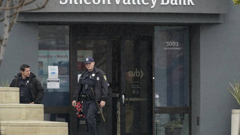 Santa Clara Police officers exit Silicon Valley Bank in Santa Clara, Calif., Friday, March 10, 2023. The Federal Deposit Insurance Corporation is seizing the assets of Silicon Valley Bank, marking the largest bank failure since Washington Mutual during the height of the 2008 financial crisis. The FDIC ordered the closure of Silicon Valley Bank and immediately took position of all deposits at the bank Friday. (AP Photo/Jeff Chiu)