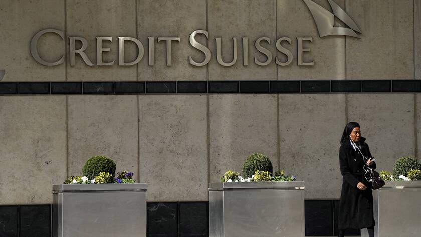 A woman walks past the Credit Suisse bank headquarters in London, Thursday, March 16, 2023. Credit Suisse's shares soared 30% on Thursday after it announced it will move to shore up its finances by borrowing up to nearly $54 billion from the Swiss central bank, bolstering confidence as fears about the banking system moved from the U.S. to Europe.(AP Photo/Frank Augstein)