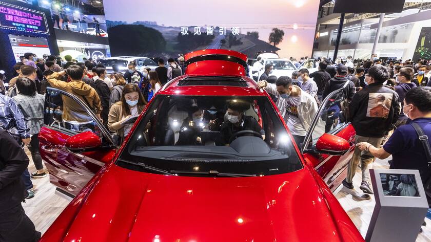epa09148987 Visitors look at cars on display at the BYD trade fair stand during the first day of the Auto Shanghai 2021 motor show in Shanghai, China, 21 April 2021. The 19th International Automobile Industry Exhibition runs from 24 to 28 April. EPA/Alex Plavevski