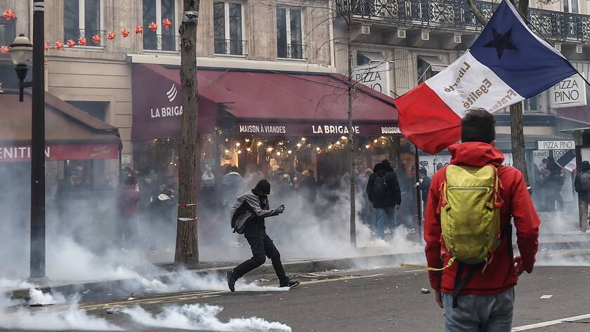 A Protester kicks a tear gas bomb during clashes with anti-riot police, during a protest against government pension reform in Paris, France, 23 March 2023. P