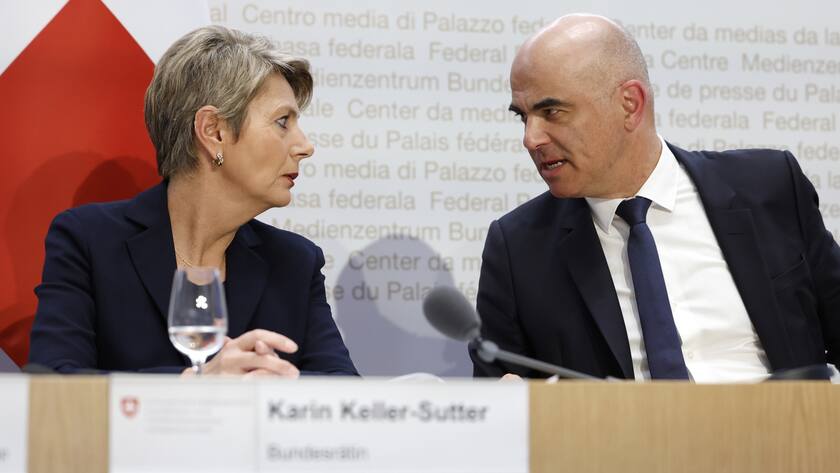 Swiss Finance Minister Karin Keller-Sutter, left, and Swiss Federal President Alain Berset discuss during a press conference, on Sunday, 19 March 2023 in Bern. Switzerland's largest bank UBS agreed to take over Credit Suisse for $3 billion Swiss francs ($3.25 billion) in a government-brokered deal over the weekend following days of market upheaval over the health of the banking sector. (KEYSTONE/Peter Klaunzer)
