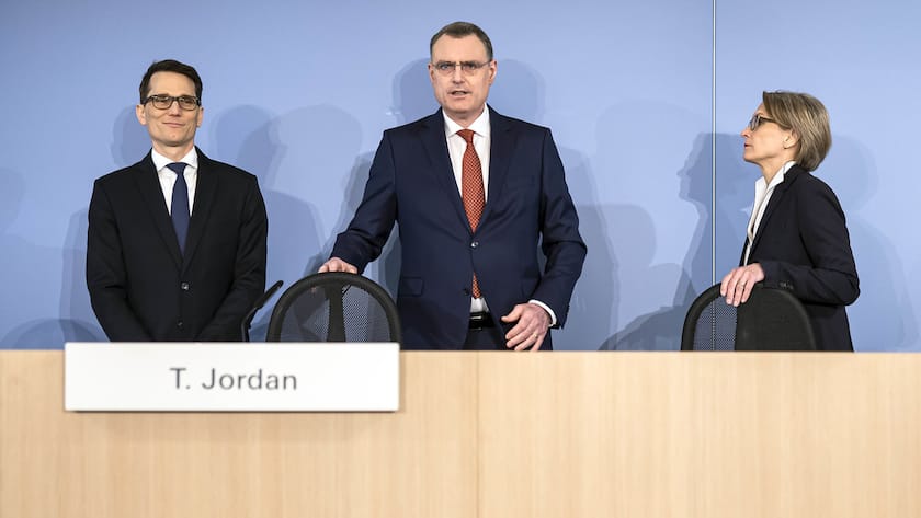 Swiss National Bank's (SNB) Chairman of the Governing Board Thomas Jordan, center, Vice Chairman of the Governing Board Martin Schlegel, left, and Member of the Governing Board Andrea Maechler, right, arrive to a media briefing of the Swiss National Bank in Zurich, Switzerland, on Thursday, March 23, 2023. (KEYSTONE/Michael Buholzer).