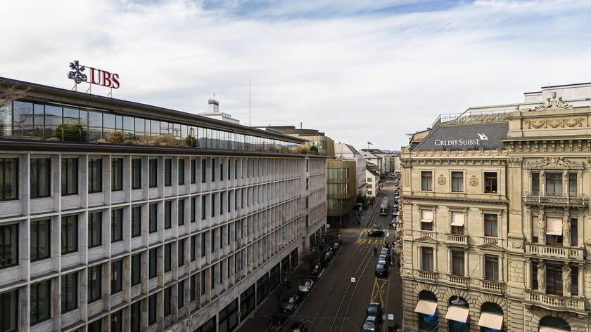 A general view shows the headquarters of the Swiss bank Credit Suisse, right, and UBS, left, at Paradeplatz in in Zurich, Switzerland on Saturday, March 18, 2023. (KEYSTONE/Michael Buholzer).