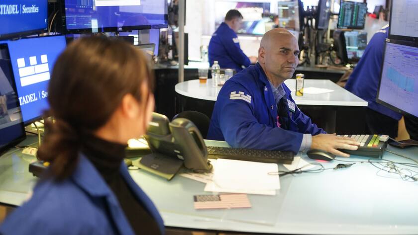 Traders work on the floor at the New York Stock Exchange in New York, Tuesday, March 28, 2023. (AP Photo/Seth Wenig)
