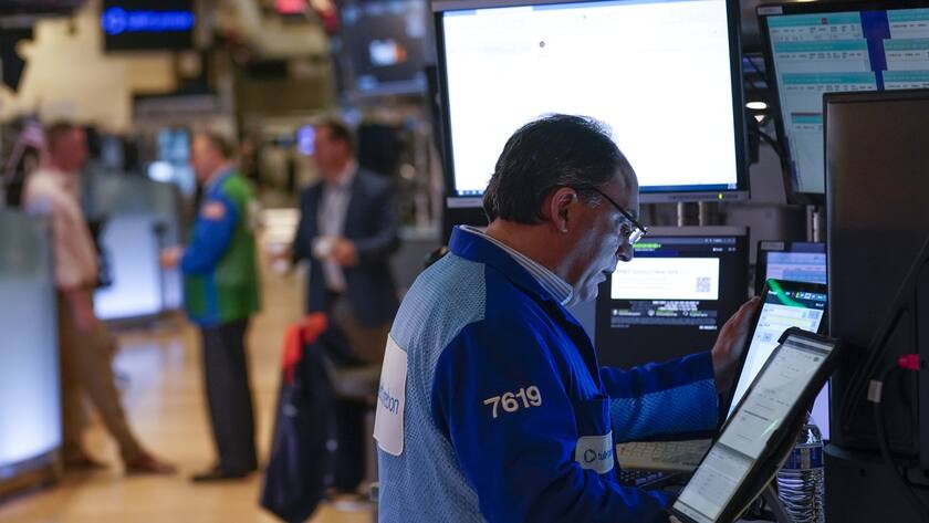 Traders work on the floor at the New York Stock Exchange in New York, Monday, April 17, 2023. (AP Photo/Seth Wenig)