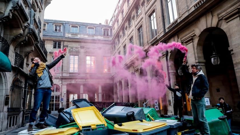 ctivists gather garbage bins and light flares at the entrance to the Constitutional Council during a protest in Paris, France, 13 April 2023. T