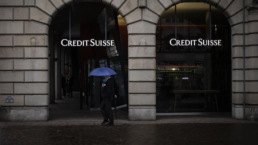 A person walks past a logo of the Swiss bank Credit Suisse in Zurich, Switzerland, on Friday, March 24, 2023. (KEYSTONE/Michael Buholzer).