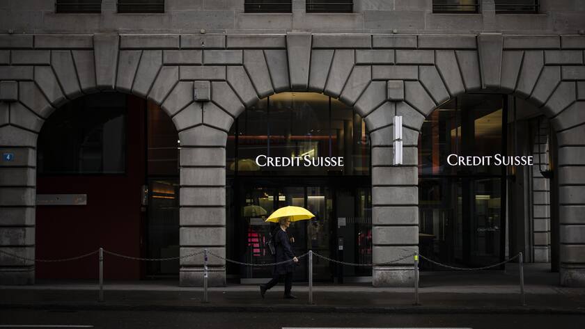 A person walks past a logo of the Swiss bank Credit Suisse in Zurich, Switzerland, on Friday, March 24, 2023. (KEYSTONE/Michael Buholzer).
