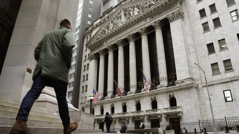 People pass the front of the New York Stock Exchange, March 22, 2023. Average Wall Street bonuses dropped sharply last year amid lagging profits and recession fears, New York state's comptroller reported Thursday.(AP Photo/Peter Morgan, File)
