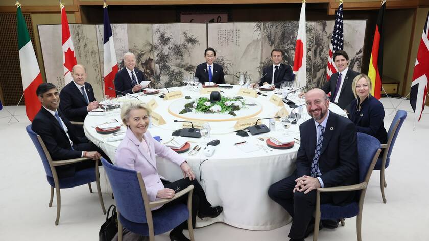 A handout photo made available by the G7 Hiroshima Summit Host shows (L-R front, clockwise) European Commission President Ursula von der Leyen, Britain's Prime Minister Rishi Sunak, Germany's Chancellor Olaf Scholz, US President Joe Biden, Japan's Prime Minister Fumio Kishida, France's President Emmanuel Macron, Canada's Prime Minister Justin Trudeau, Italy's Prime Minister Giorgia Meloni and European Council President Charles Michel posing for a group photo at a working dinner during the G7 Hiroshima Summi