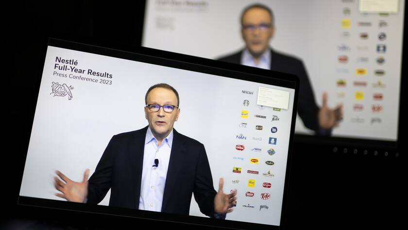 Nestle's CEO Ulf Mark Schneider appears on two screens and speaks for the 2022 full-year results virtual press conference of the food and drinks giant Nestle, in Bern, Switzerland, Thursday, February 16, 2023. (KEYSTONE/Anthony Anex)