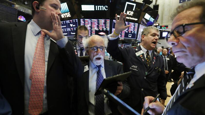 New York Stock Exchange Floor Governor Brendan Connolly, left, works with traders Peter Tuchman, John Panin and Sal Suarino, second left to right, on the floor of the NYSE, Monday, March 9, 2020. The Dow Jones Industrial Average plummeted 1,500 points, or 6%, following similar drops in Europe after a fight among major crude-producing countries jolted investors already on edge about the widening fallout from the outbreak of the new coronavirus. (AP Photo/Richard Drew)