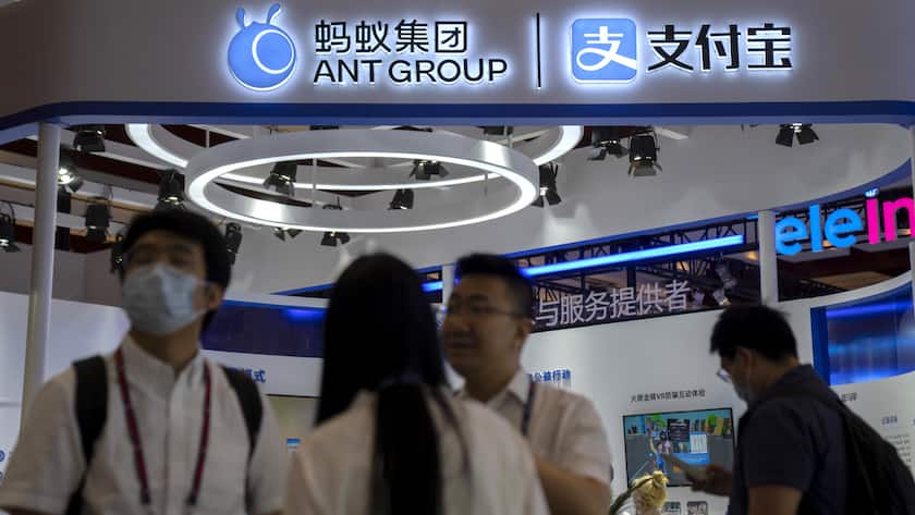 Visitors walk past a display from Chinese financial services platforms Ant Group and Alipay at the PT Expo in Beijing, Sunday, June 4, 2023. The annual expo showcases Chinese and foreign technology firms. (AP Photo/Mark Schiefelbein)