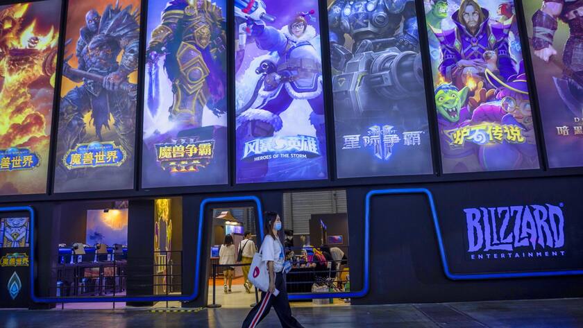 epa09693179 (FILE) - A woman passes by Blizzard booth in the ChinaJoy expo in Shanghai, China, 02 August 2020 (reissued 18 January 2022). Microsoft on 18 January 2022 in a press release confirmed it will acquire video games giant Activision Blizzard "in an all-cash transaction valued at 68.7 billion US dollars." The deal forms the biggest takeover by Microsoft to date. EPA/ALEX PLAVEVSKI *** Local Caption *** 56250826