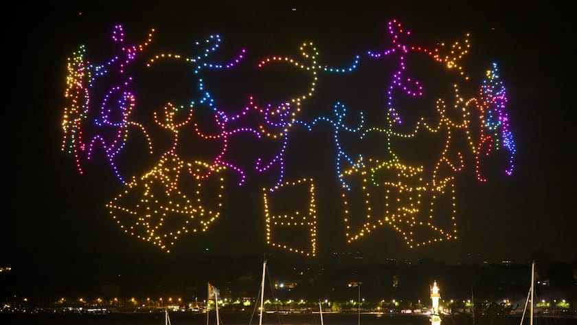 A drone night-time light show illuminates the night sky over the harbour area, in Geneva, Switzerland, Thursday, May 18, 2023. As a part of the four-day "Feu O Lac" events, more than 1350 drones illuminated the sky over the Lake Geneva during the first edition of the largest drone show in Europe. (KEYSTONE/Laurent Gillieron)