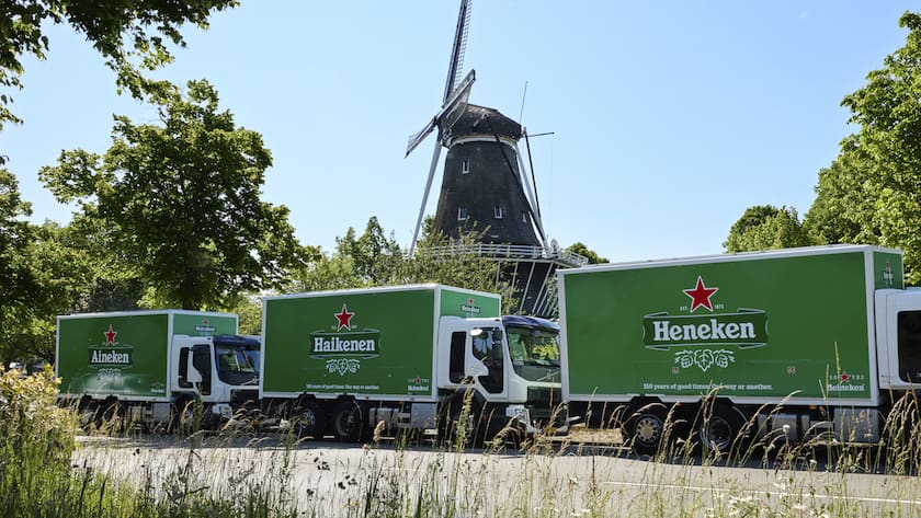 In this image released on Tuesday, June, 13, 2023, three Heineken trucks drive by a windmill in the Netherlands to deliver the world's most widely recognised – yet misspelled – beer brand.