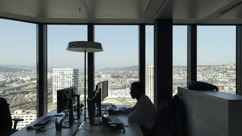 A GAM employee works at his desk in an office at the Prime Tower, a skyscraper, where the pure play asset management group GAM is headquartered, pictured in Zurich, Switzerland, on March 13, 2017. (KEYSTONE/Gaetan Bally)