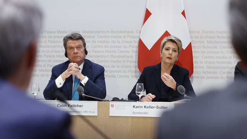 Swiss Finance Minister Karin Keller-Sutter, right, speaks beside Colm Kelleher, Chairman UBS, during a press conference, on Sunday, 19 March 2023 in Bern. Switzerland's largest bank UBS agreed to take over Credit Suisse for 3 billion Swiss francs ($3.25 billion) in a government-brokered deal over the weekend following days of market upheaval over the health of the banking sector. (KEYSTONE/Peter Klaunzer)