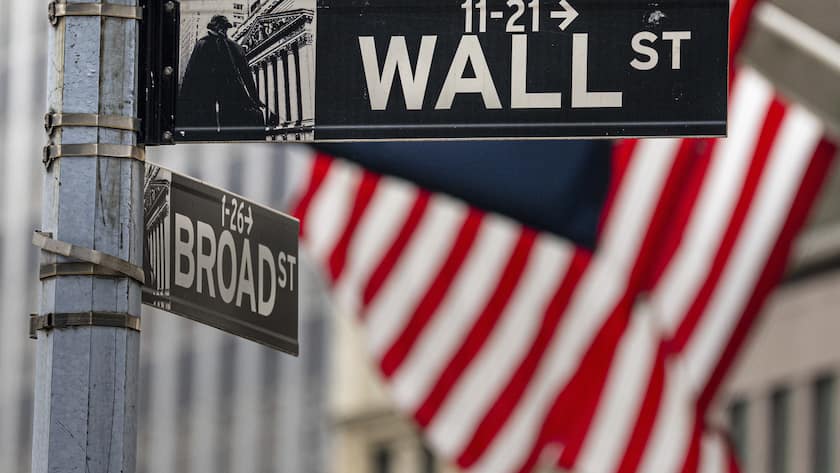 Street signs at the center of the New York City financial district frame the U.S. Flags flying from the front of the New York Stock Exchange, Wednesday, Aug. 16, 2023. Wall Street is drifting Wednesday and stocks are mixed a day after their latest tumble in what's been a messy August. (AP Photo/J. David Ake)