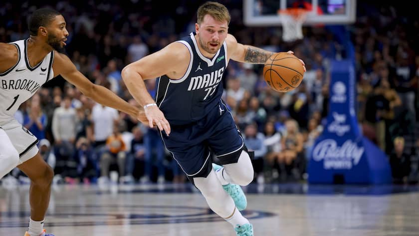 Dallas Mavericks guard Luka Doncic (77) drives to the basket as Brooklyn Nets forward Mikal Bridges (1) defends during the second half of an NBA basketball game Friday, Oct. 27, 2023, in Dallas. (AP Photo/Gareth Patterson)