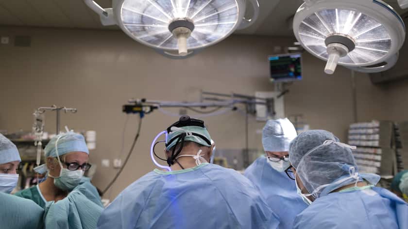 Swiss heart surgeon and pediatrician Rene Pretre (center, pictured from behind) and his team perform cardiac surgery on a two-year-old child at the Lausanne University Hospital, Centre Hospitalier Universitaire Vaudois, CHUV, in Lausanne, Canton of Vaud, Switzerland, on August 23, 2016. (KEYSTONE/Gaetan Bally)