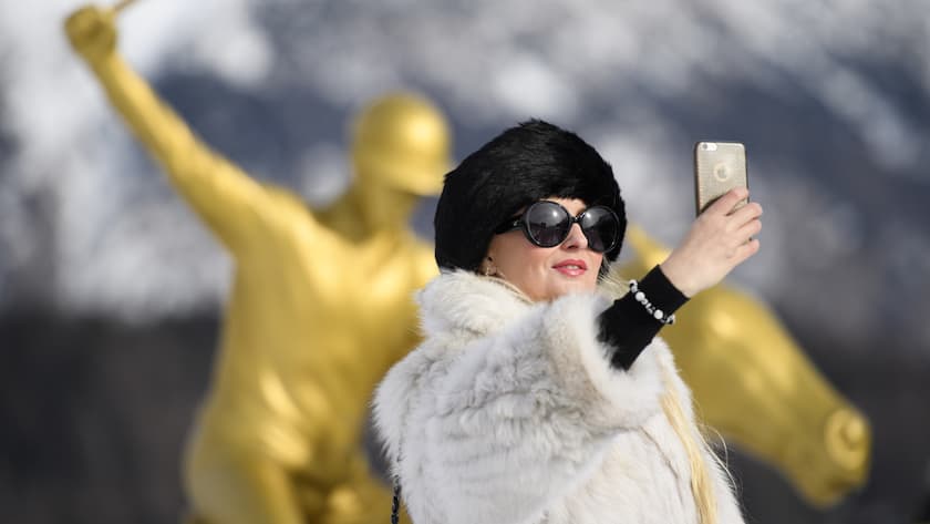 A visitor in fur coat takes a selfie during the Snow Polo World Cup Tournament, on Saturday, January 28, 2017, in St. Moritz, Switzerland. (KEYSTONE/Gian Ehrenzeller)